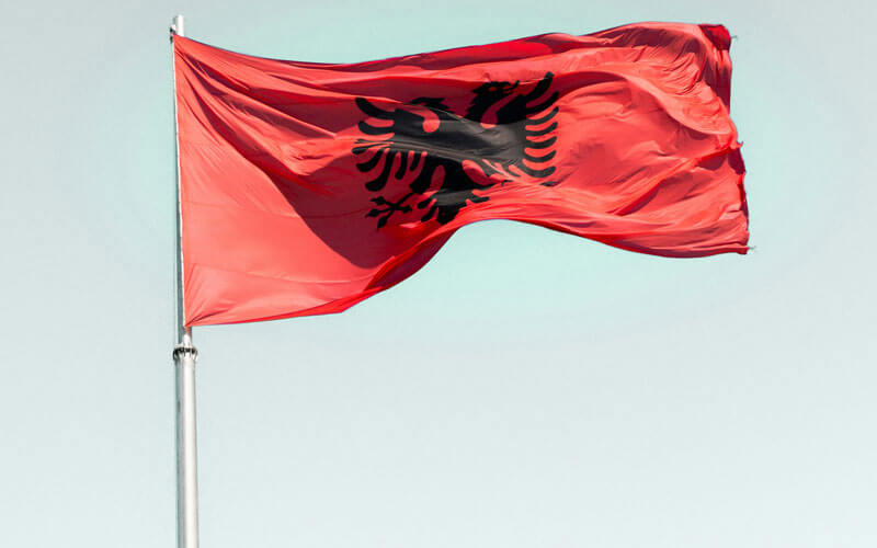 The red Albanian flag fluttering in the breeze