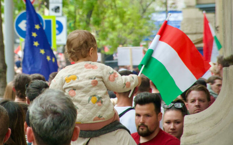 Baby Carrying Hungary Flag on the Street