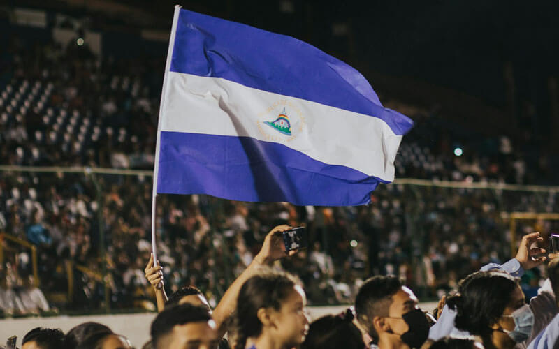 Crowd waving blue white Nicaragua flag at the stadium