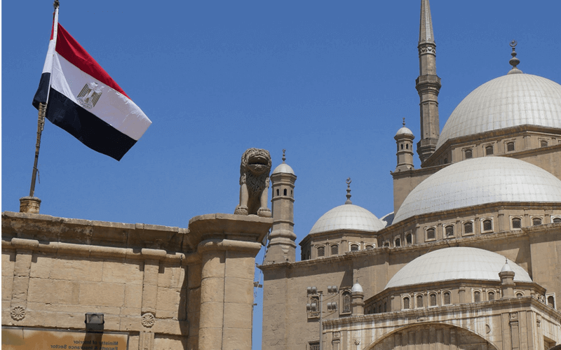 Egyptian flag besides the traditional building with domes