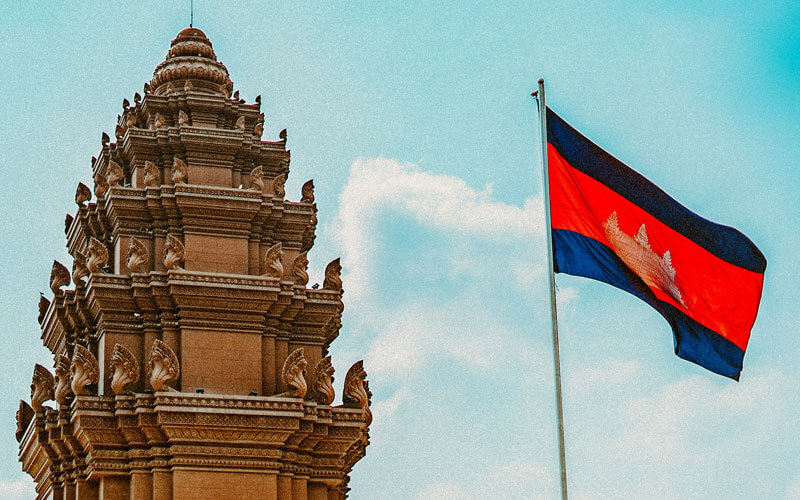 Flag of Cambodia near the traditional sculptured building