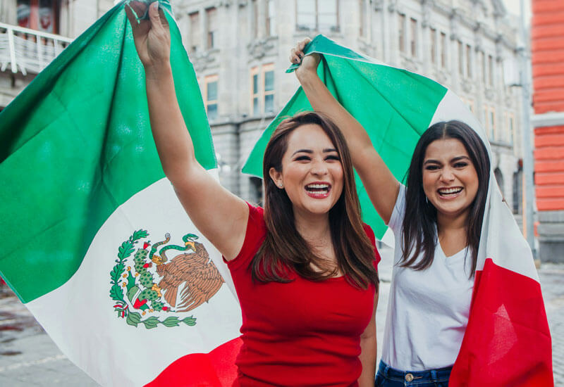 Girls holding Mexican Flag