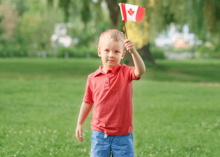 Kid waving red and white canadian flag