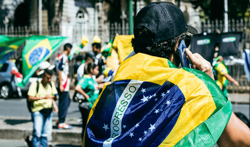 Man holding brazalian flag as cape
