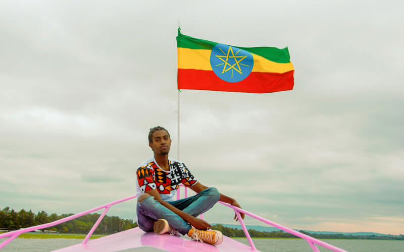 Man on boat with Flag of Ethiopia
