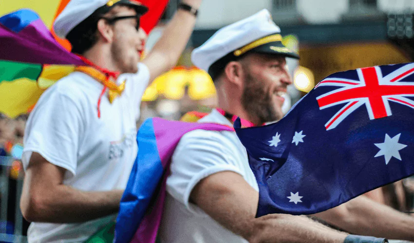 Man riding with flag of australia during the pride parade