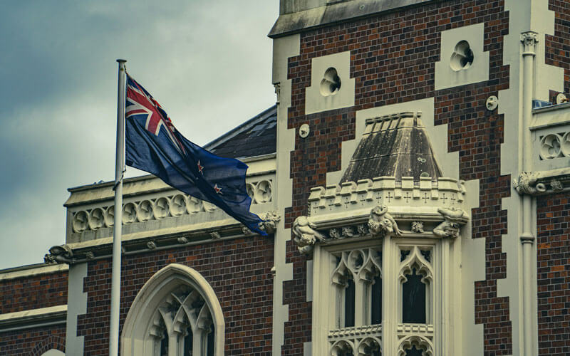 New Zealand flag infront of the old building