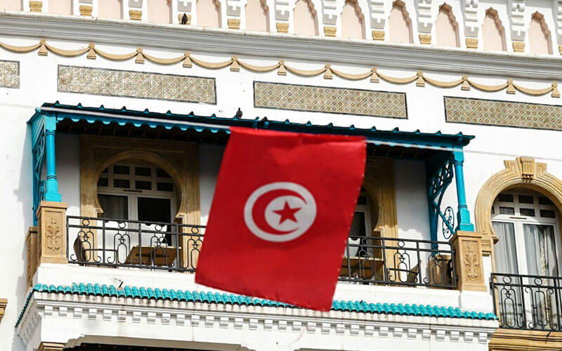 Red Tunisian flag infront of the building