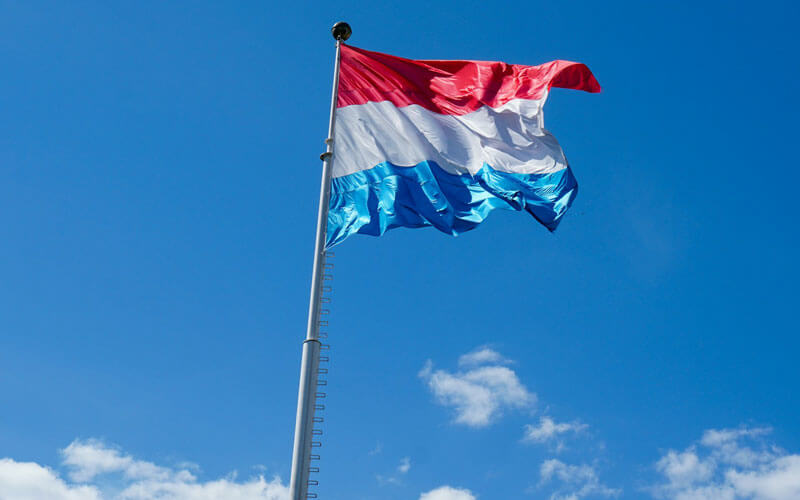 Red, white and blue flag of Luxembourg waving in the wind