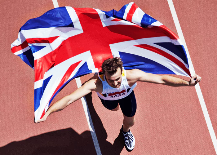 Sportsman holding the UK flag in a stadium