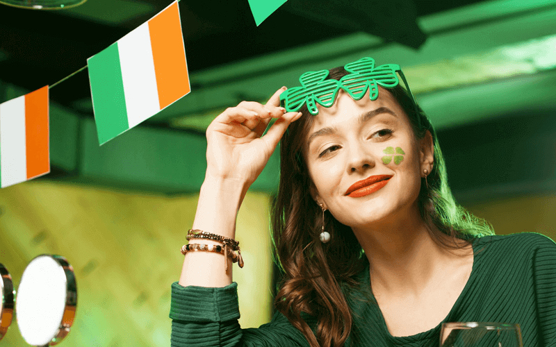 String of Irish flags in the restraurant above the woman dressed in green