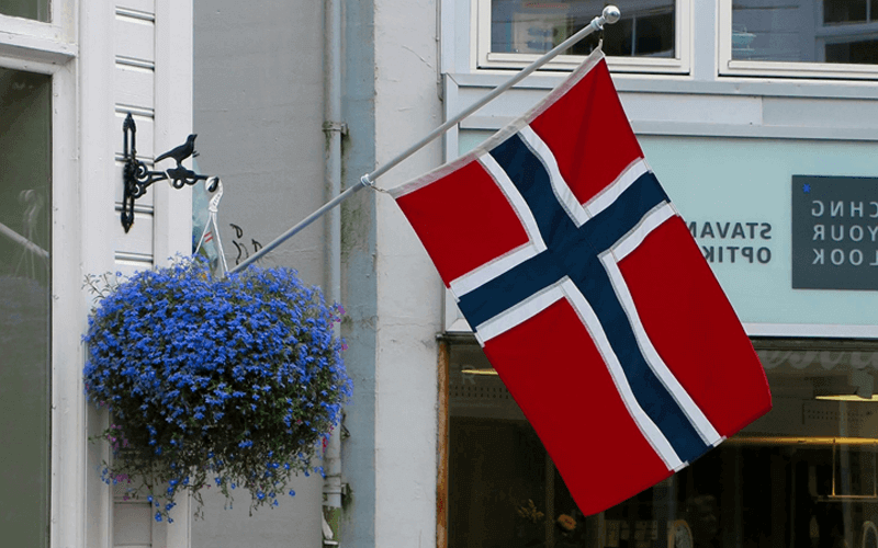 The Norwegian flag waving outside the building