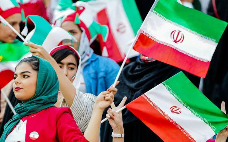 Women waving Iranian flag at the stadium
